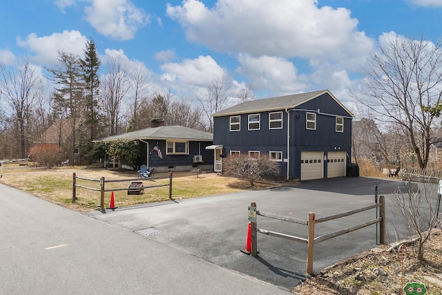 11 Elm Dr, York, ME 03909 - view of front facade featuring an attached garage, aphalt driveway, and fence