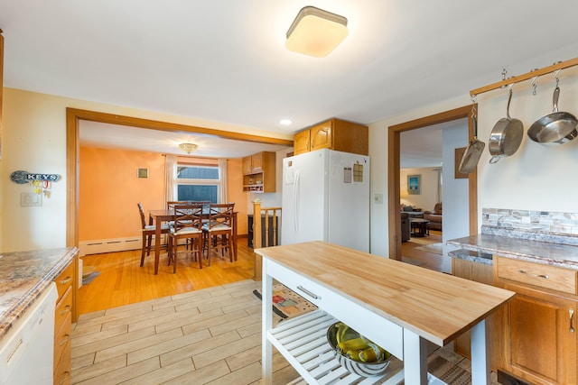 11 Elm Dr, York, ME 03909 - kitchen with brown cabinetry, a baseboard radiator, light wood finished floors, and white appliances