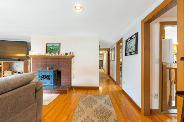 11 Elm Dr, York, ME 03909 - living room featuring baseboards, light wood-type flooring, and a brick fireplace