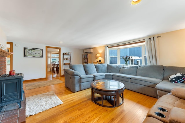 11 Elm Dr, York, ME 03909 - living room featuring a wood stove, recessed lighting, wood finished floors, and a wall mounted air conditioner