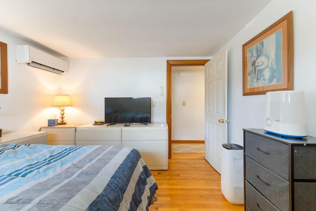 11 Elm Dr, York, ME 03909 - bedroom featuring an AC wall unit, baseboards, and light wood-type flooring