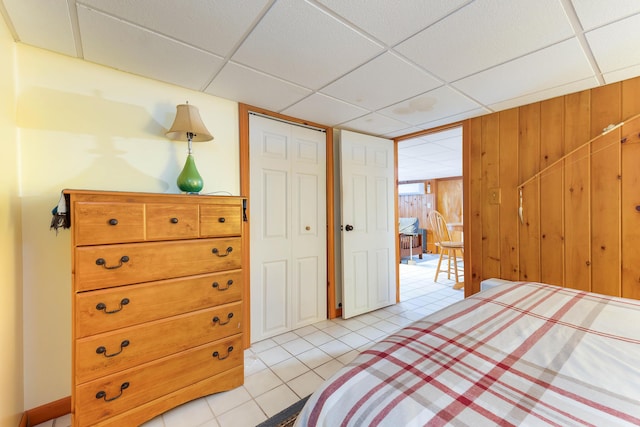 11 Elm Dr, York, ME 03909 - bedroom featuring light tile patterned floors, a paneled ceiling, and wood walls