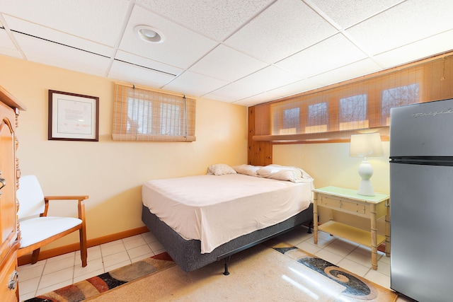 11 Elm Dr, York, ME 03909 - tiled bedroom with a paneled ceiling, baseboards, and freestanding refrigerator