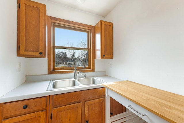 11 Elm Dr, York, ME 03909 - kitchen with a sink, brown cabinetry, and light countertops