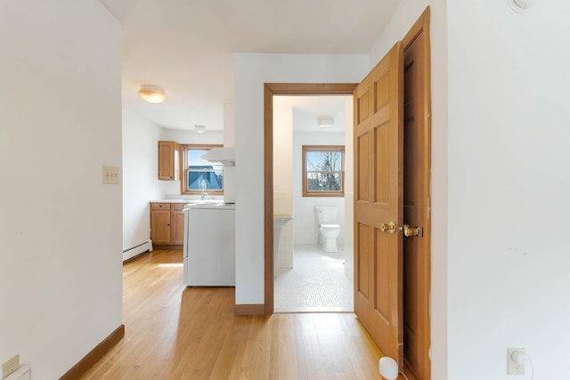 11 Elm Dr, York, ME 03909 - hall featuring light wood-style flooring, a baseboard radiator, and a sink