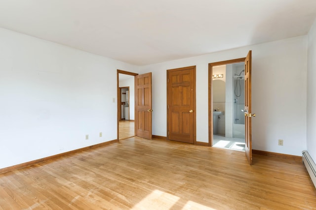 11 Elm Dr, York, ME 03909 - unfurnished bedroom featuring baseboards, light wood-type flooring, connected bathroom, and baseboard heating