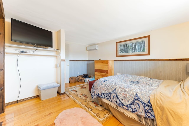 11 Elm Dr, York, ME 03909 - bedroom featuring an AC wall unit, wainscoting, and wood finished floors