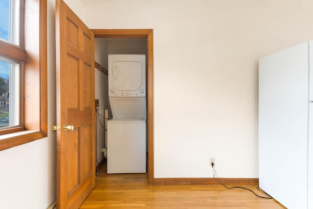 11 Elm Dr, York, ME 03909 - washroom with baseboards, light wood-style floors, stacked washer / dryer, and laundry area