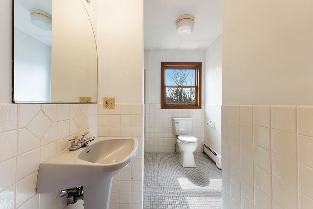 11 Elm Dr, York, ME 03909 - bathroom with tile patterned floors, baseboard heating, tile walls, and toilet