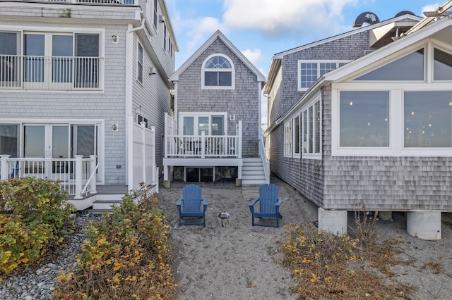 back of house featuring stairway and french doors