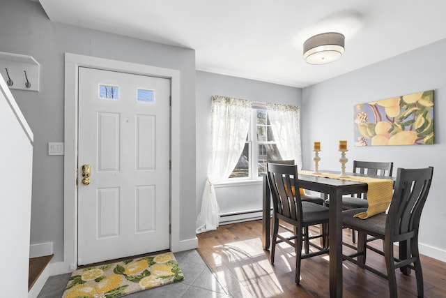 dining area with dark wood-type flooring, baseboards, and a baseboard radiator