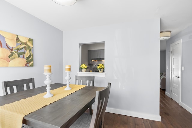 dining space featuring baseboards and wood finished floors