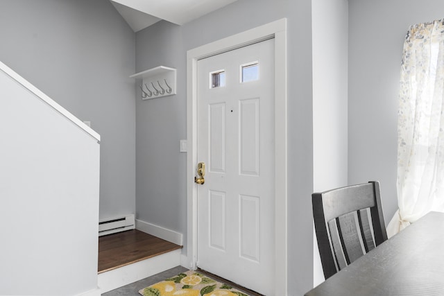 entryway featuring a baseboard heating unit and baseboards