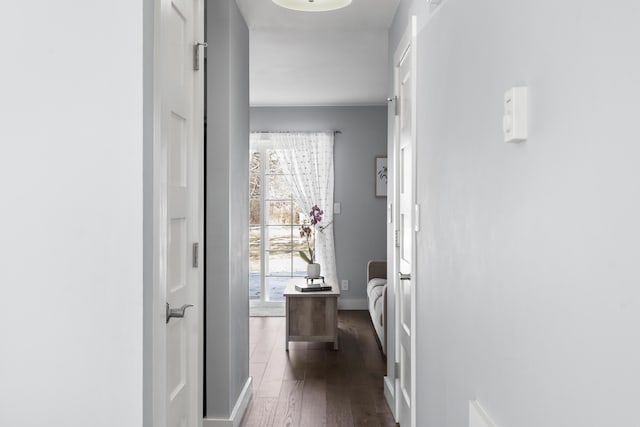 corridor featuring dark wood-style floors and baseboards