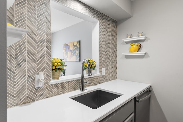 kitchen with open shelves, dishwasher, light countertops, and a sink