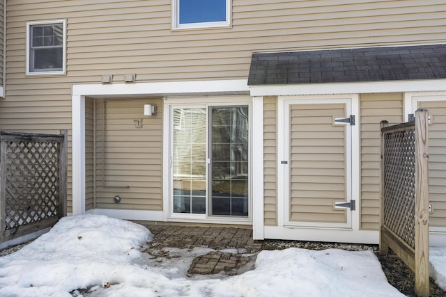 doorway to property featuring a shingled roof