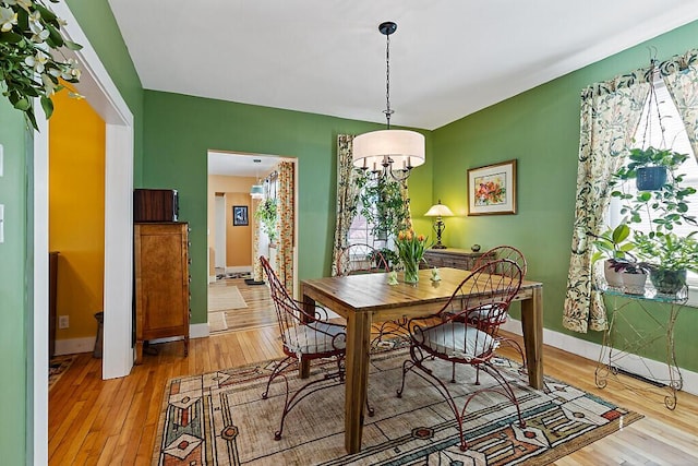 dining room with baseboards and light wood-style floors