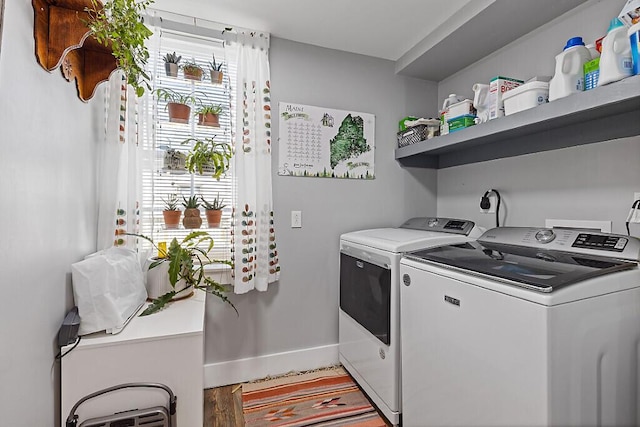 clothes washing area with laundry area, baseboards, and independent washer and dryer