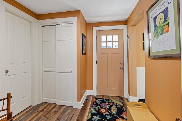 foyer entrance featuring dark wood-style floors and baseboards