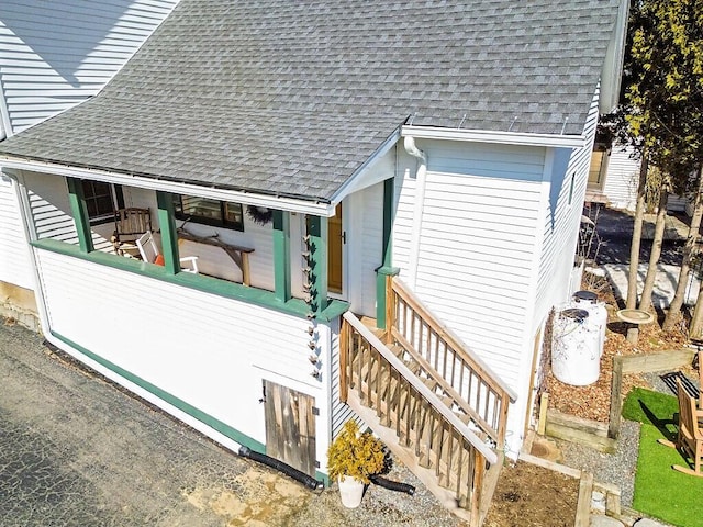 view of property exterior with a shingled roof