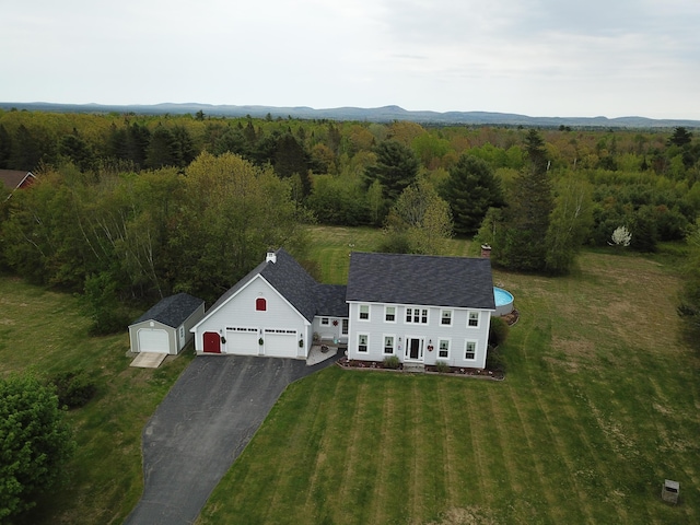 bird's eye view with a wooded view