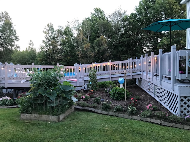 view of yard featuring a vegetable garden and a deck