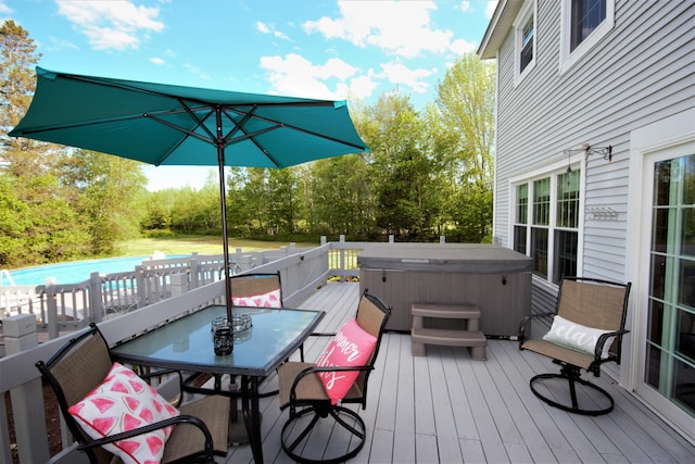 deck featuring a swimming pool, a hot tub, and outdoor dining area