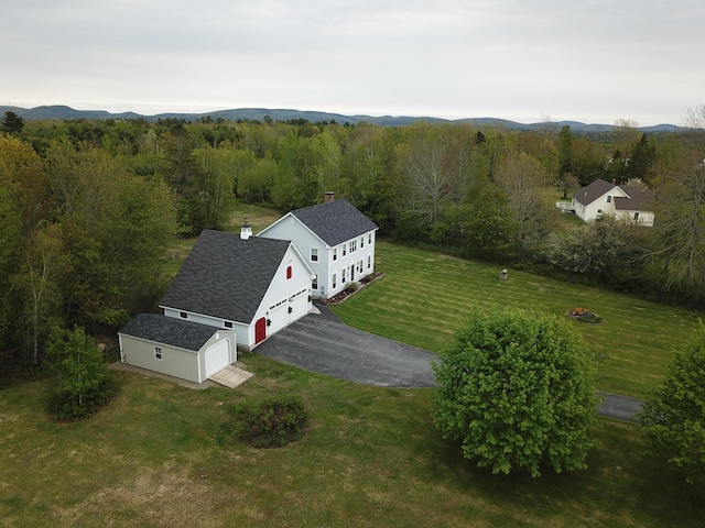 birds eye view of property featuring a forest view and a mountain view