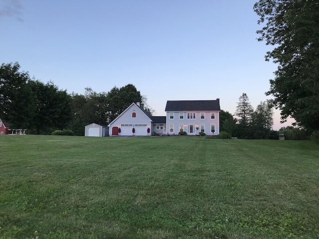 view of yard with a garage and an outdoor structure