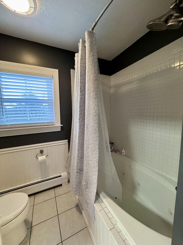 full bath with toilet, a textured ceiling, wainscoting, tile patterned flooring, and baseboard heating