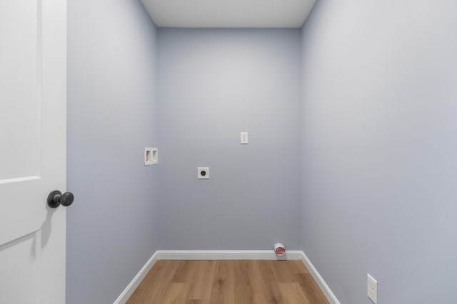 laundry room featuring light wood finished floors, baseboards, hookup for an electric dryer, hookup for a washing machine, and laundry area