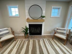 living area with a fireplace and baseboards