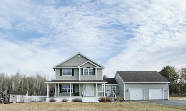 view of front facade featuring fence, aphalt driveway, roof with shingles, covered porch, and an attached garage