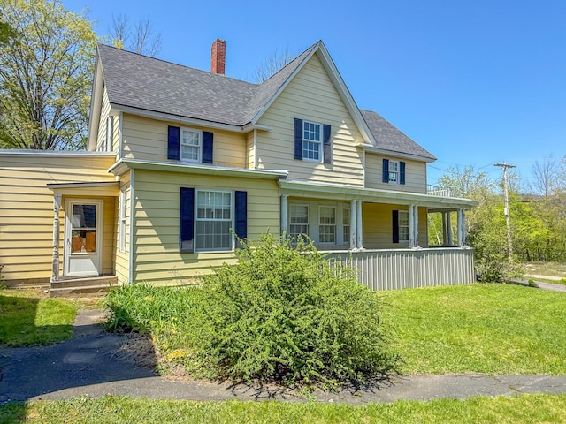 39 Washington St, Rumford, ME 04276 - view of front of home featuring a chimney, covered porch, a shingled roof, and a front yard