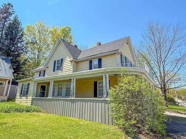 39 Washington St, Rumford, ME 04276 - view of property exterior with covered porch, a chimney, roof with shingles, and a yard