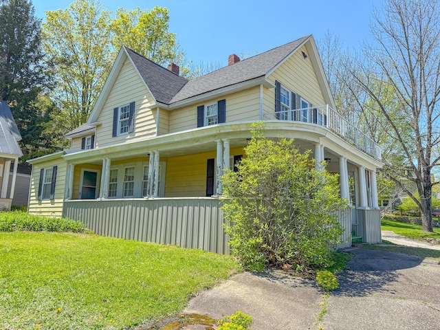 39 Washington St, Rumford, ME 04276 - view of front facade featuring covered porch, a chimney, a shingled roof, and a front lawn