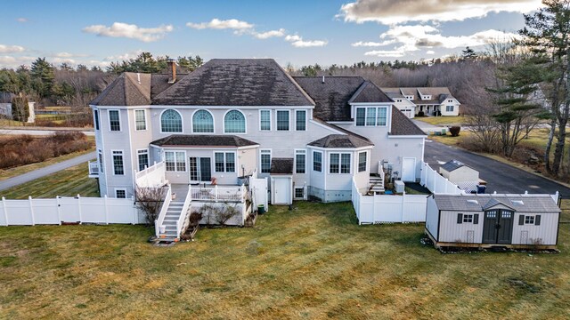 16 Ocean Greens Dr, Saco, ME 04072 - rear view of house featuring an outbuilding, a fenced backyard, a storage shed, and a yard