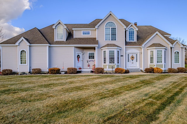 16 Ocean Greens Dr, Saco, ME 04072 - view of front of home featuring a front yard and a shingled roof