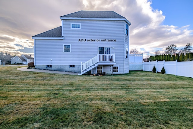 16 Ocean Greens Dr, Saco, ME 04072 - back of house featuring a shingled roof, fence, stairway, and a yard