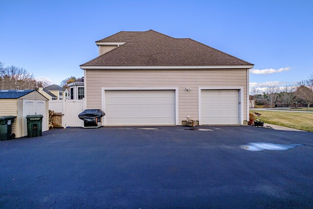 16 Ocean Greens Dr, Saco, ME 04072 - garage featuring fence and aphalt driveway