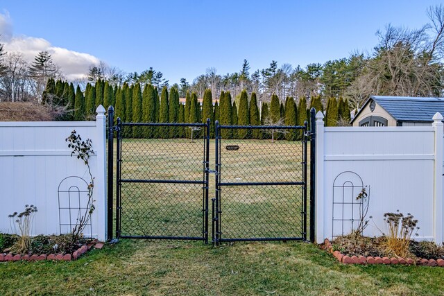 16 Ocean Greens Dr, Saco, ME 04072 - view of gate featuring fence and a lawn