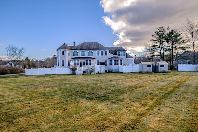 16 Ocean Greens Dr, Saco, ME 04072 - back of house with an outbuilding, a fenced backyard, a yard, and a shed