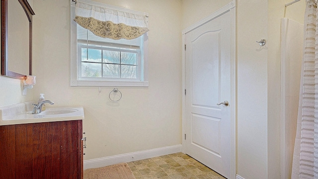 16 Ocean Greens Dr, Saco, ME 04072 - bathroom featuring tile patterned floors, vanity, and baseboards