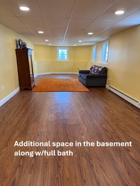 16 Ocean Greens Dr, Saco, ME 04072 - unfurnished room with a paneled ceiling, baseboard heating, baseboards, and wood finished floors