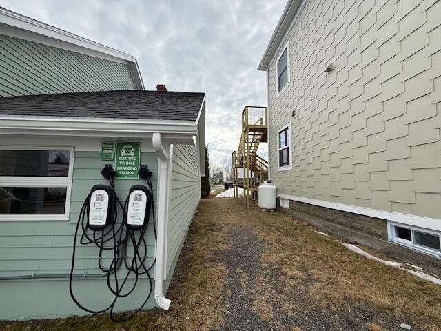 6 School St, Lubec, ME 04652 - view of side of property featuring stairway and roof with shingles