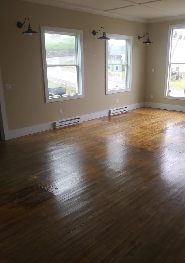 6 School St, Lubec, ME 04652 - empty room with crown molding, baseboard heating, baseboards, and wood-type flooring
