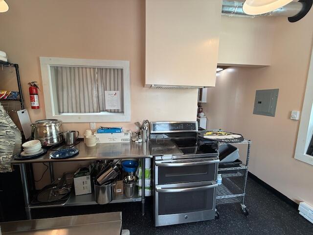 6 School St, Lubec, ME 04652 - kitchen with range with two ovens, baseboards, and electric panel