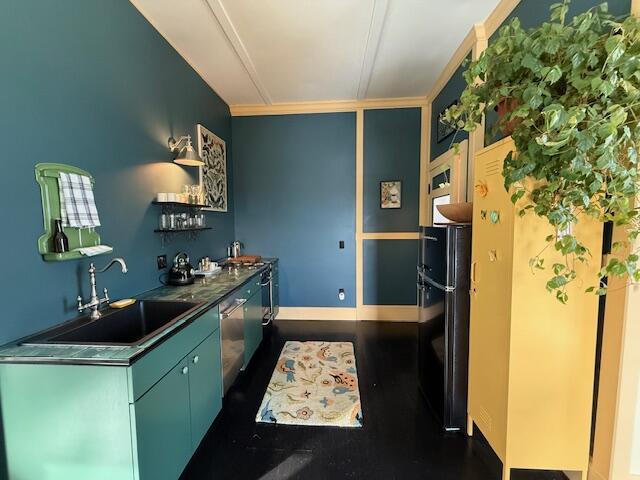 6 School St, Lubec, ME 04652 - kitchen featuring dark wood-type flooring, a sink, stainless steel counters, open shelves, and freestanding refrigerator