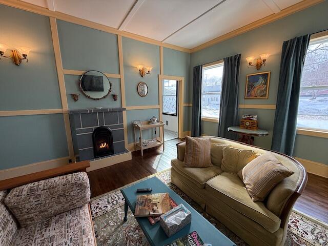 6 School St, Lubec, ME 04652 - living area with a fireplace, crown molding, wood finished floors, and baseboards