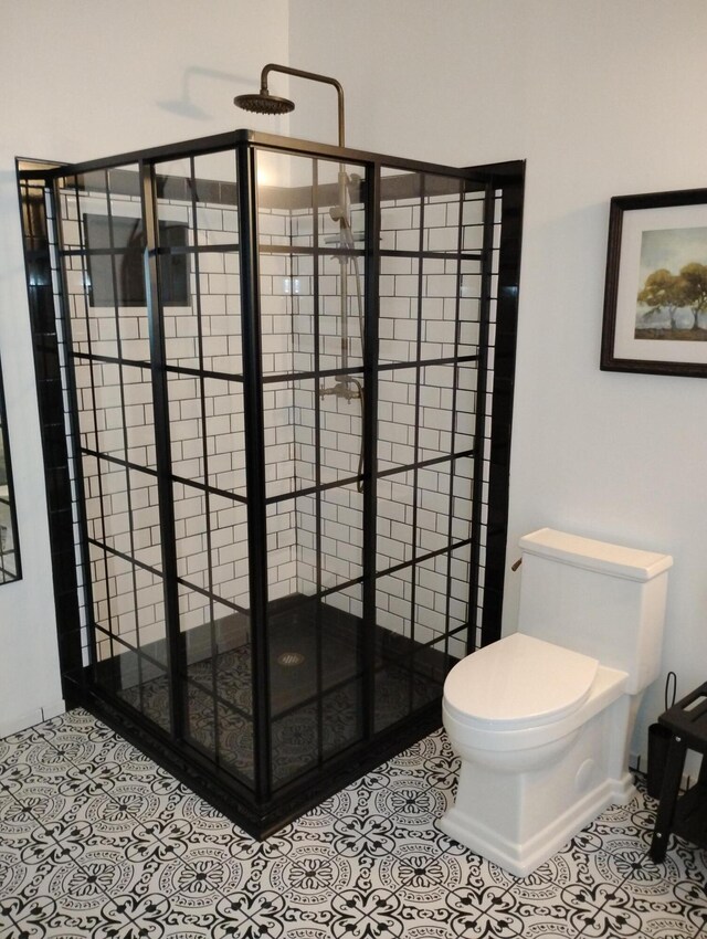 6 School St, Lubec, ME 04652 - bathroom featuring tile patterned floors, toilet, and a shower stall